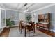 Bright dining room featuring hardwood floors, a modern light fixture, and traditional furnishings at 4105 Peachtree Dunwoody Ne Rd, Atlanta, GA 30342