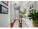 Bright hallway with wood floors, plants, natural light, and artwork enhancing the architectural details at 4105 Peachtree Dunwoody Ne Rd, Atlanta, GA 30342