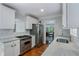 Kitchen with stainless steel appliances and granite countertops, open to dining area at 4105 Peachtree Dunwoody Ne Rd, Atlanta, GA 30342