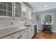 Kitchen with stainless steel faucet, bright granite counters, subway tile backsplash, and white cabinetry at 4105 Peachtree Dunwoody Ne Rd, Atlanta, GA 30342
