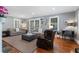 Spacious living room featuring a fireplace, hardwood floors, and comfortable seating at 4105 Peachtree Dunwoody Ne Rd, Atlanta, GA 30342