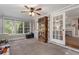 Light-filled sunroom with large windows, carpeted floor, and stylish decor at 4105 Peachtree Dunwoody Ne Rd, Atlanta, GA 30342