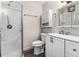 Bathroom with tiled shower, modern white vanity with drawers and cabinet and updated fixtures at 520 Cranberry Pl, Roswell, GA 30076
