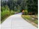 Picturesque view of smooth and paved bike trail, framed by green vegetation at 520 Cranberry Pl, Roswell, GA 30076