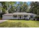 Charming single-story home with inviting front porch, bench, and manicured lawn at 520 Cranberry Pl, Roswell, GA 30076