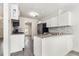 Modern kitchen with white cabinets, gray backsplash, and stainless steel appliances at 520 Cranberry Pl, Roswell, GA 30076