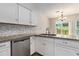 Updated kitchen with granite countertops, mosaic backsplash, and stainless steel appliances at 520 Cranberry Pl, Roswell, GA 30076