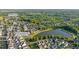 Aerial neighborhood view displaying the community lake and lush greenery with street names visible for easy navigation at 7120 Lullwater Rd, Cumming, GA 30040