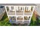 Aerial view of a three-story home with multiple balconies and outdoor seating areas at 7120 Lullwater Rd, Cumming, GA 30040