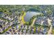 Neighborhood aerial showcasing community lake, winding roads, and mature trees lining the cozy residential streets at 7120 Lullwater Rd, Cumming, GA 30040