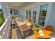 Inviting balcony featuring a fire pit, cozy seating, and scenic views through the sliding glass doors at 7120 Lullwater Rd, Cumming, GA 30040