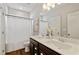 Well-appointed bathroom featuring double sinks, a large mirror, and a shower/tub combination with modern fixtures at 7120 Lullwater Rd, Cumming, GA 30040