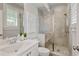 Modern bathroom features a glass-enclosed shower, white vanity, and stylish fixtures at 7120 Lullwater Rd, Cumming, GA 30040
