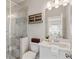 Modern bathroom with a glass-enclosed shower, stylish vanity, and decorative shelving at 7120 Lullwater Rd, Cumming, GA 30040