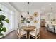 Bright dining area with wood floors, shiplap accent wall, and a modern light fixture at 7120 Lullwater Rd, Cumming, GA 30040