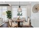 Charming dining area with a round table, natural light, and stylish decor creates an inviting atmosphere at 7120 Lullwater Rd, Cumming, GA 30040