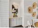 Dining area with shiplap walls featuring a stylish gray cabinet with granite countertops and decorative wicker art at 7120 Lullwater Rd, Cumming, GA 30040