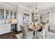 Elegant dining room featuring a chandelier, a wet bar, and seating for six at 7120 Lullwater Rd, Cumming, GA 30040