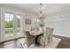 Sunlit dining room with a chandelier and doors leading to a private balcony at 7120 Lullwater Rd, Cumming, GA 30040