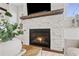 Close up shot of a stone fireplace with dark wood trim and a built-in firebox at 7120 Lullwater Rd, Cumming, GA 30040