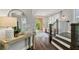 Bright foyer with hardwood floors, white walls, staircase, and stylish decor at 7120 Lullwater Rd, Cumming, GA 30040