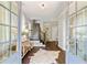 Bright foyer with hardwood floors, white walls, staircase, and stylish decor at 7120 Lullwater Rd, Cumming, GA 30040
