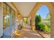 Charming covered front porch with brick archways, a welcome mat, and comfortable seating at 7120 Lullwater Rd, Cumming, GA 30040