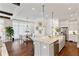 Open-concept kitchen featuring a large island, stainless steel appliances, and seamless access to the dining area at 7120 Lullwater Rd, Cumming, GA 30040