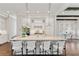 Bright kitchen boasts a large center island with seating, complemented by white cabinetry and stainless steel appliances at 7120 Lullwater Rd, Cumming, GA 30040