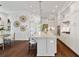 Open kitchen with a large island, white cabinets, and hardwood floors, ideal for cooking and entertaining at 7120 Lullwater Rd, Cumming, GA 30040