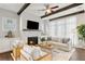Living room with stone fireplace, dark wood beams, and comfortable seating arrangement at 7120 Lullwater Rd, Cumming, GA 30040