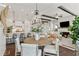 Open-concept design showcasing dining area, kitchen with island seating, and living room with fireplace at 7120 Lullwater Rd, Cumming, GA 30040
