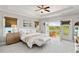 Serene main bedroom with a tray ceiling, deck access, and a comfortable bed at 7120 Lullwater Rd, Cumming, GA 30040