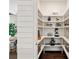 Walk-in pantry with custom shelving provides ample storage for groceries and kitchen essentials at 7120 Lullwater Rd, Cumming, GA 30040