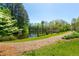 Picturesque pond view featuring a walking path and lush greenery at 7120 Lullwater Rd, Cumming, GA 30040
