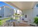 Charming porch with outdoor dining, white railings, and a view of neighboring homes at 7120 Lullwater Rd, Cumming, GA 30040