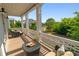 Charming porch view with seating and decorative railing overlooking a tree-lined street at 7120 Lullwater Rd, Cumming, GA 30040