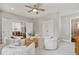 Bright sitting area with ceiling fan, four chairs, and view of foyer at 7120 Lullwater Rd, Cumming, GA 30040