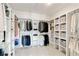 Spacious walk-in closet with custom shelving and ample storage space for clothing and accessories at 7120 Lullwater Rd, Cumming, GA 30040