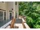 Charming back deck with outdoor seating, surrounded by a serene, lush green environment at 12350 Stevens Creek Dr, Alpharetta, GA 30005