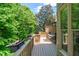 Inviting back deck with outdoor seating, surrounded by lush greenery and privacy at 12350 Stevens Creek Dr, Alpharetta, GA 30005