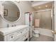 Well-lit bathroom featuring a vanity, mirror, toilet, and glass-enclosed shower at 12350 Stevens Creek Dr, Alpharetta, GA 30005