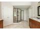 Bathroom featuring glass shower, dual sinks, and private toilet room at 12350 Stevens Creek Dr, Alpharetta, GA 30005