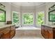 Elegant bathroom with dual vanities, a large tub, and natural light from three windows at 12350 Stevens Creek Dr, Alpharetta, GA 30005