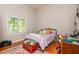 Bright bedroom with a large window offering natural light, wood floors, and a comfortable bed; a perfect personal retreat at 12350 Stevens Creek Dr, Alpharetta, GA 30005