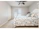 Bright bedroom features neutral walls, carpet, a window with blinds and a bed with floral bedding and pillows at 12350 Stevens Creek Dr, Alpharetta, GA 30005