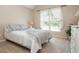 Cozy bedroom with a comfortable bed, neutral colors, and a bright window at 12350 Stevens Creek Dr, Alpharetta, GA 30005