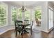 Cozy breakfast nook featuring a bay window, backyard view and access to the patio at 12350 Stevens Creek Dr, Alpharetta, GA 30005