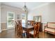 Formal dining room with hardwood floors, neutral paint, and a large window at 12350 Stevens Creek Dr, Alpharetta, GA 30005