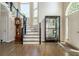 Spacious two-story foyer featuring a staircase, hardwood floors, and a large front door at 12350 Stevens Creek Dr, Alpharetta, GA 30005